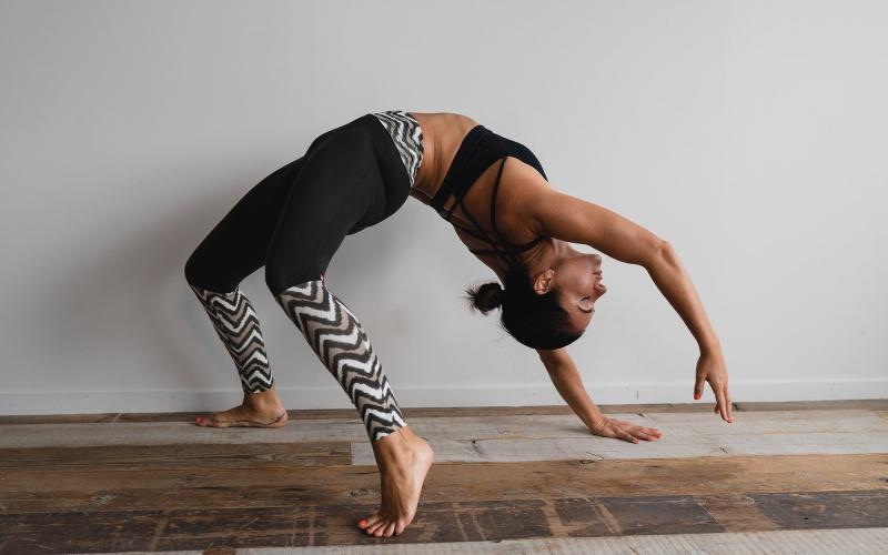 woman bending over backwards in an exercise studio