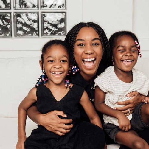 The essence of exceptional living a woman sitting on a couch with two kids